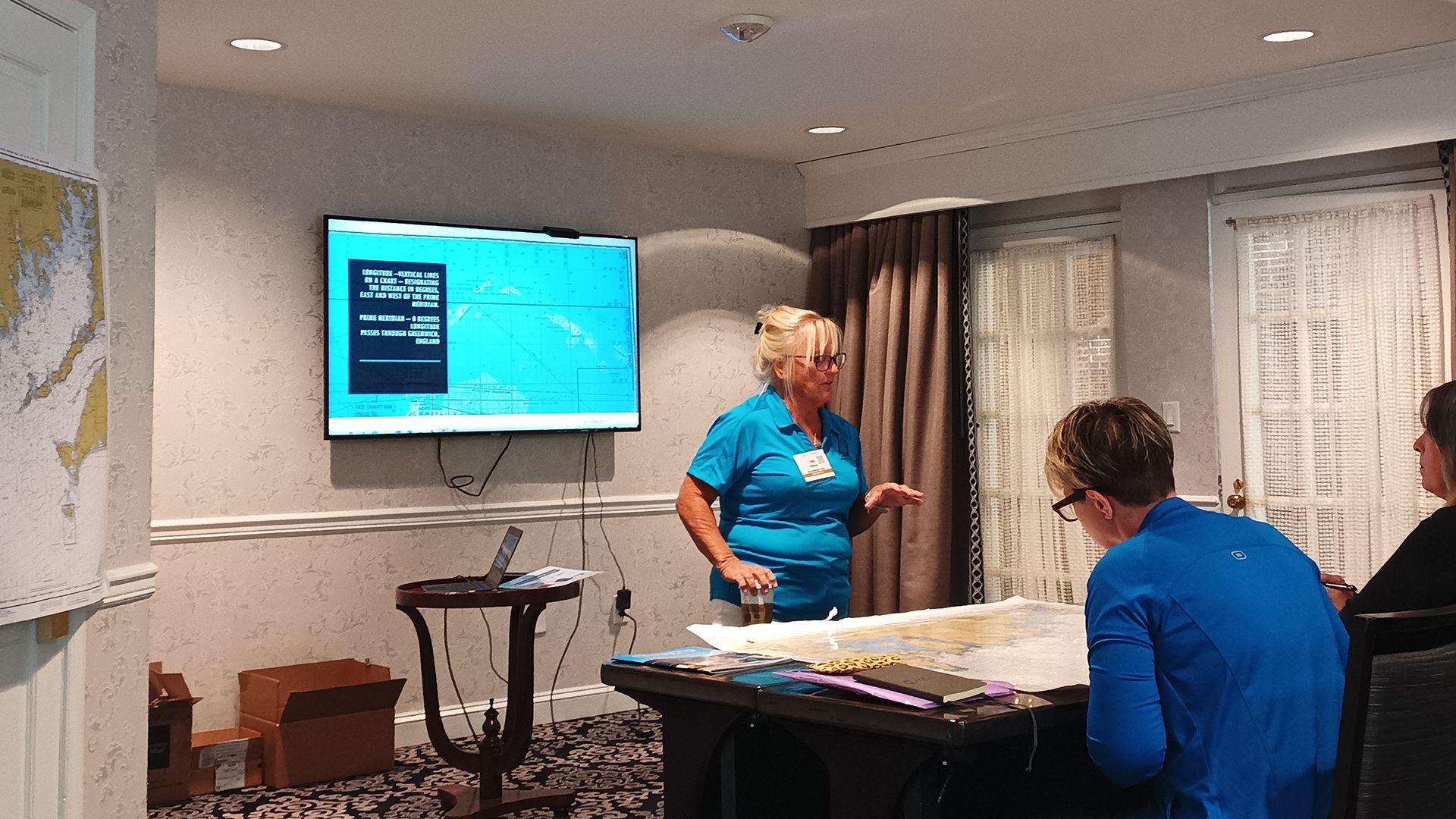 The ocean and sky with clouds at sunrise. There are sailboats in the distance.